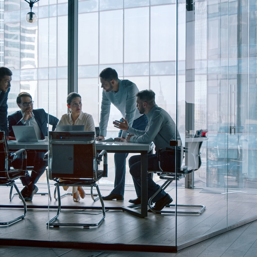 Group of business people working with technology at a meeting in a conference room